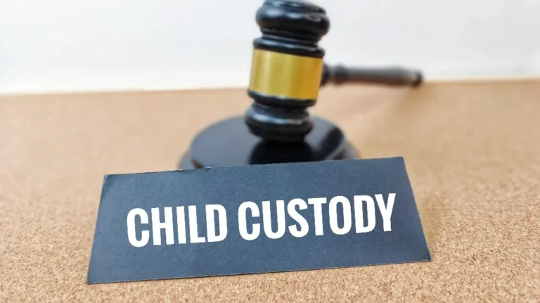 Black gavel with gold band behind a black card displaying "CHILD CUSTODY" in white text.
